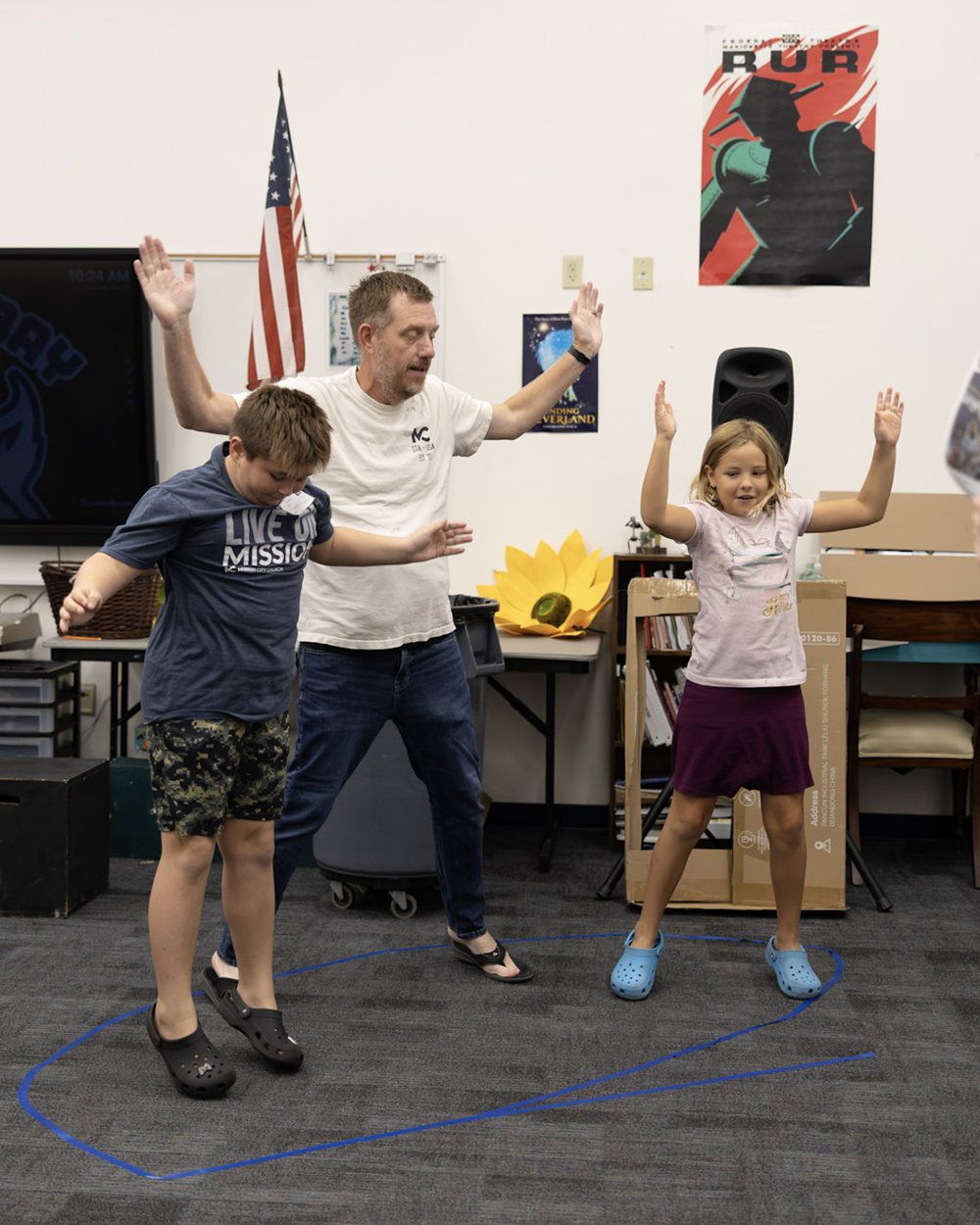 A leader and two kids doing an action game at Mission 45