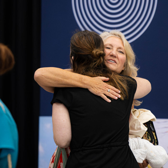 Two women greeting each other